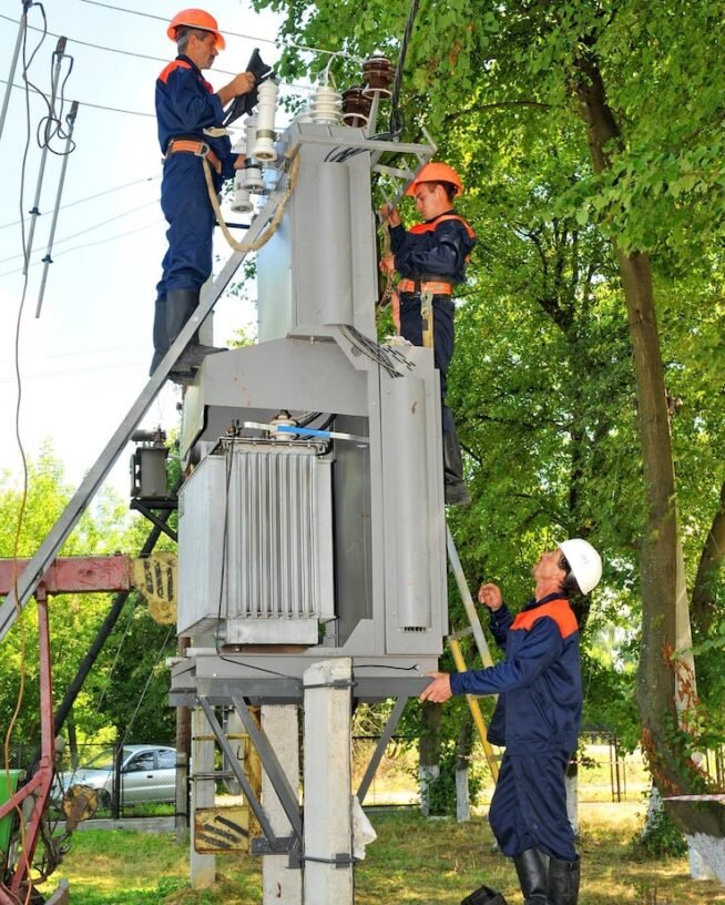 electricians-electrical-substation-replace-damaged-insulator_271853-1900